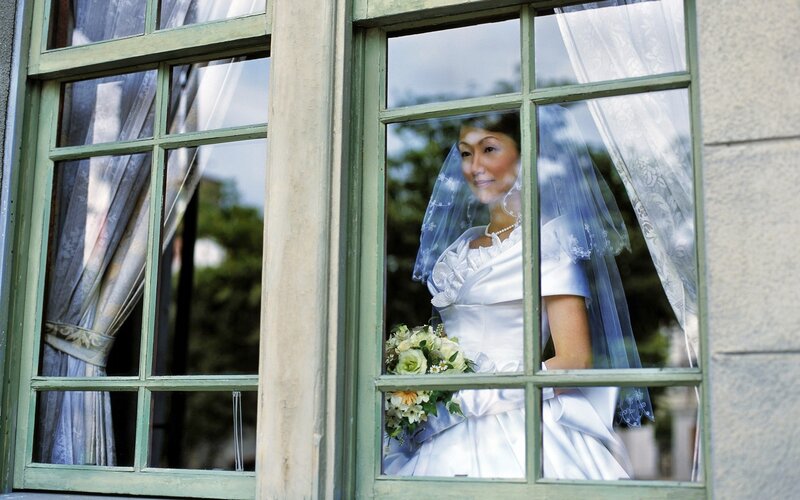 Bride looking out window