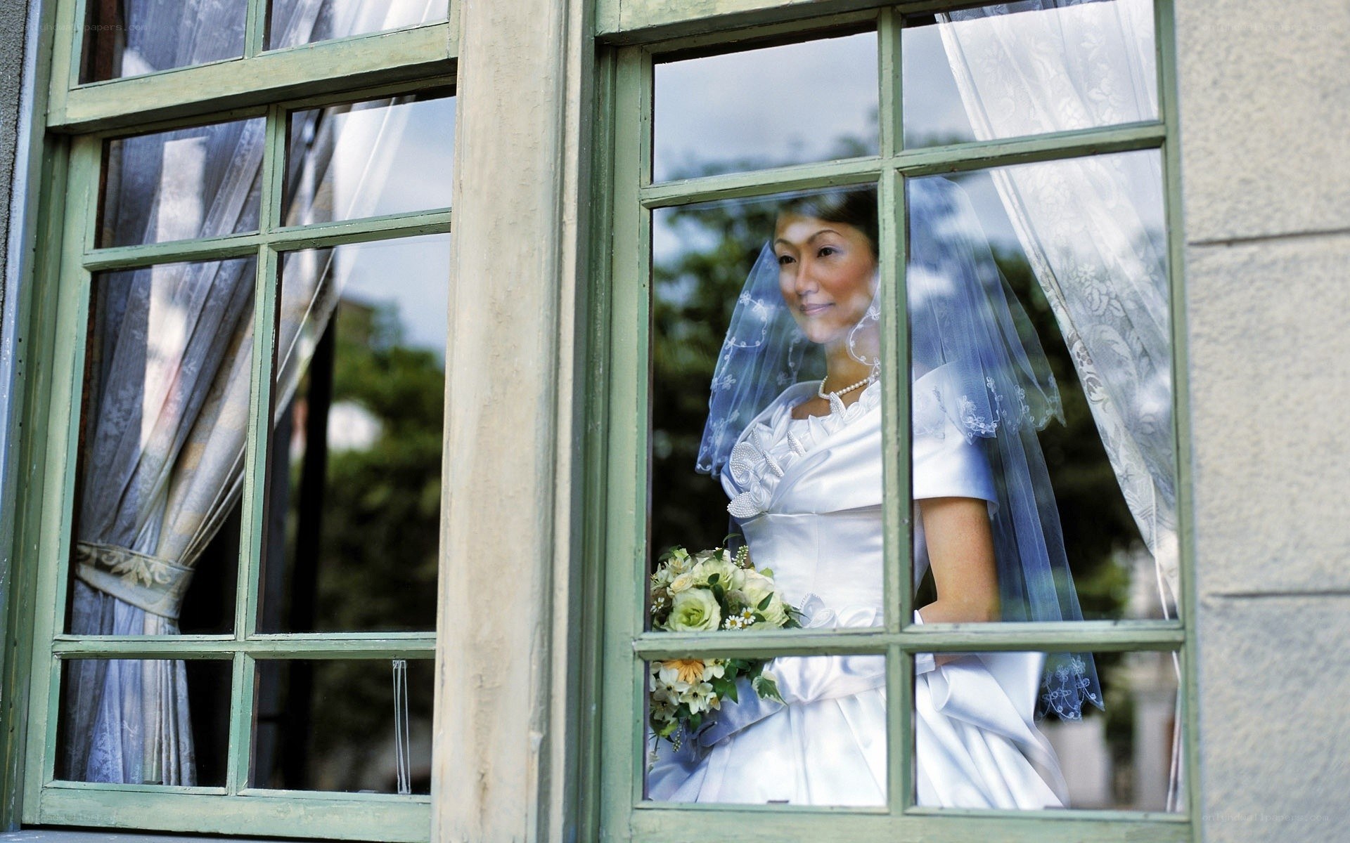 Bride looking out window