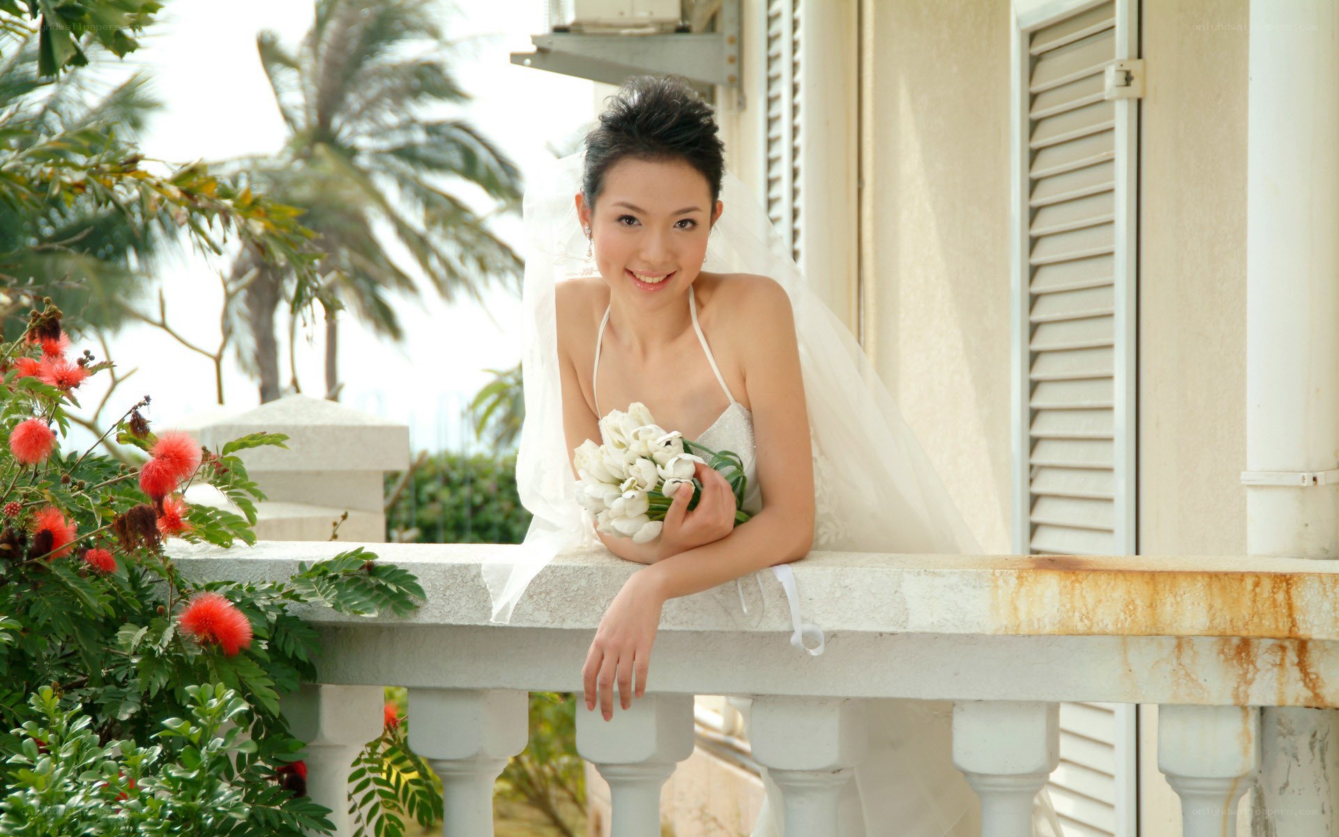 Bride on a balcony with flowers