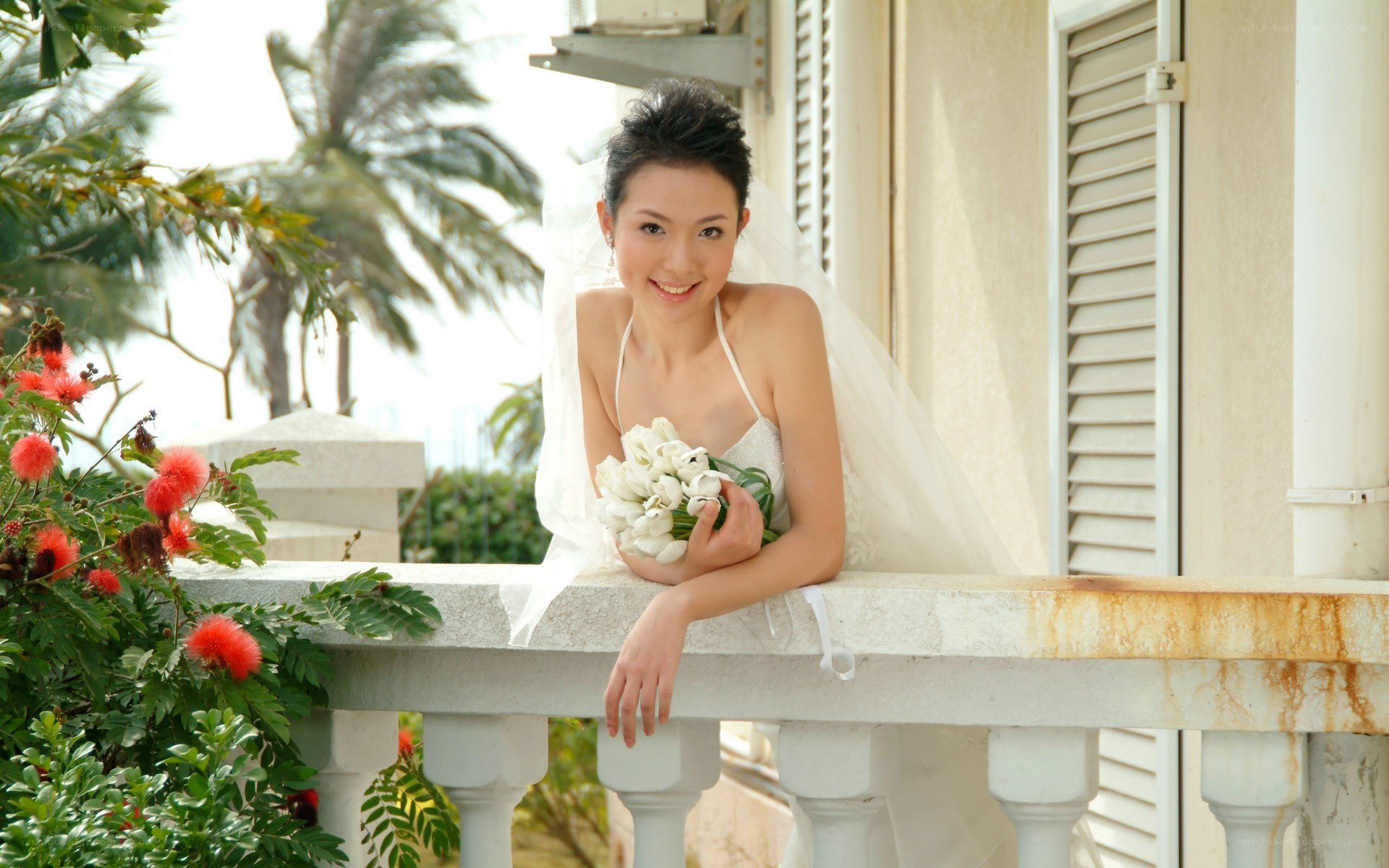 Bride on a balcony with flowers