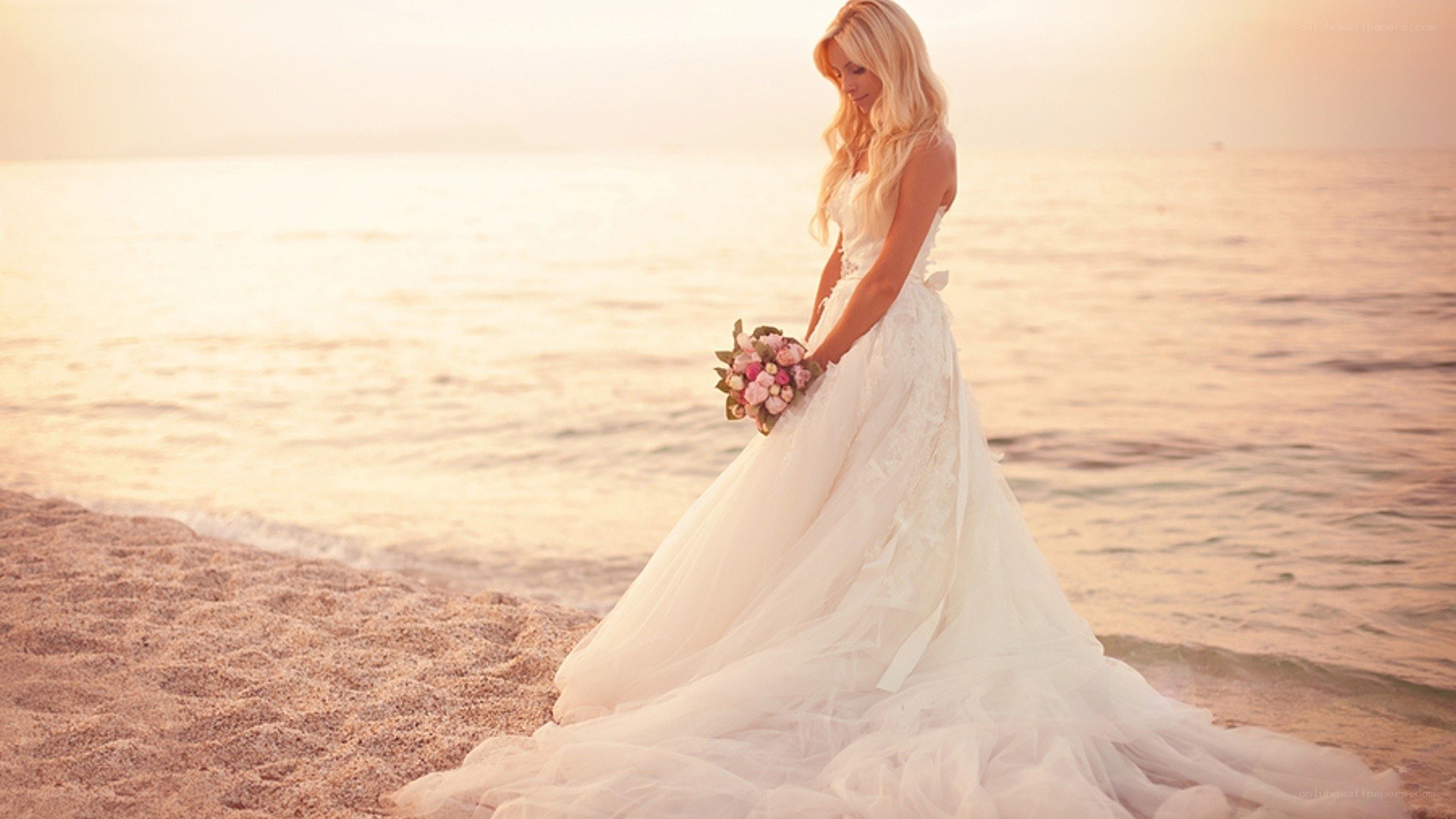 Bride on the beach at sunset