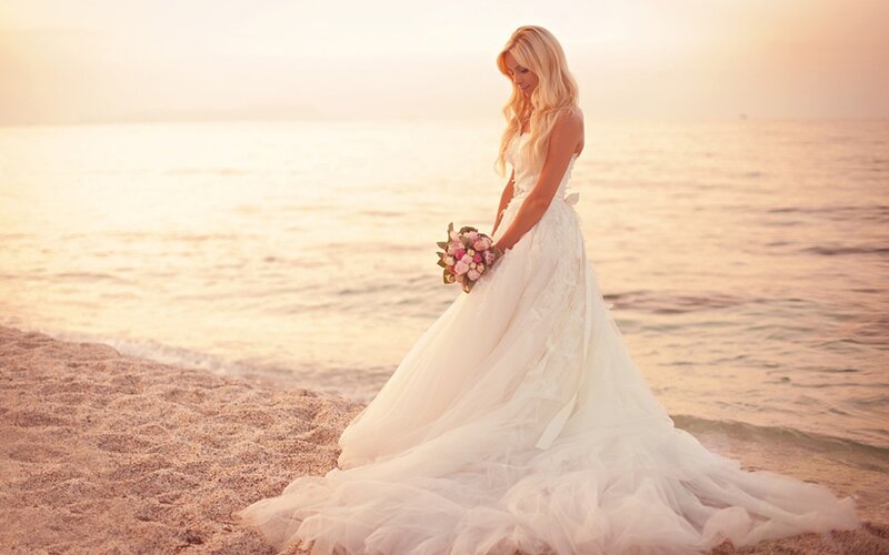 Bride on the beach at sunset