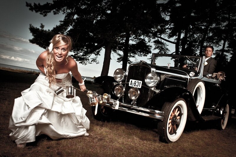 Bride pulling vintage car