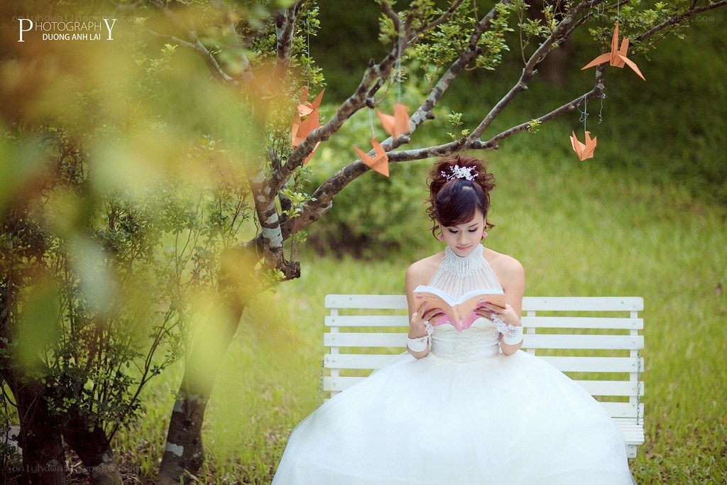 Bride reading under a tree
