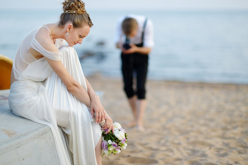 Bride Sitting on Beach