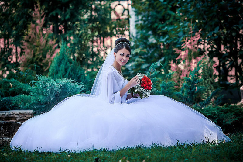 Bride Sitting on Grass