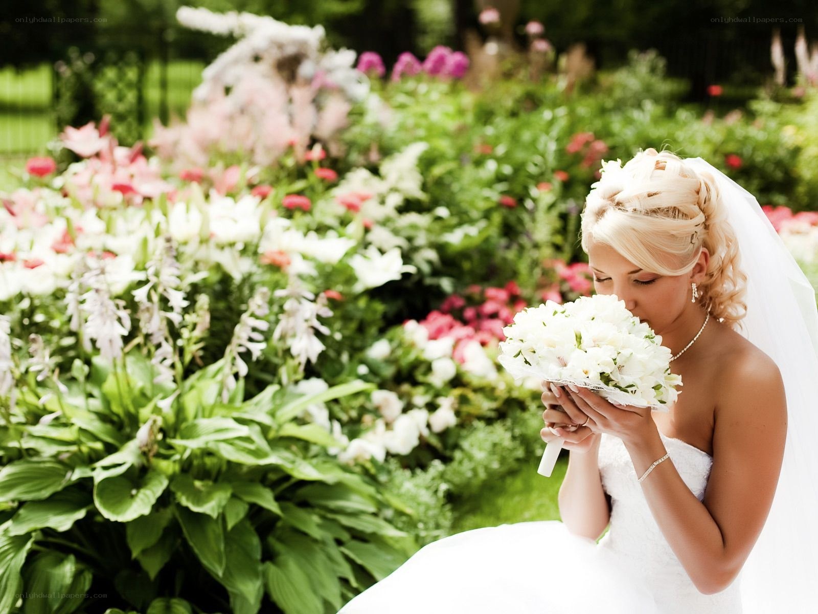 Bride with bouquet in garden