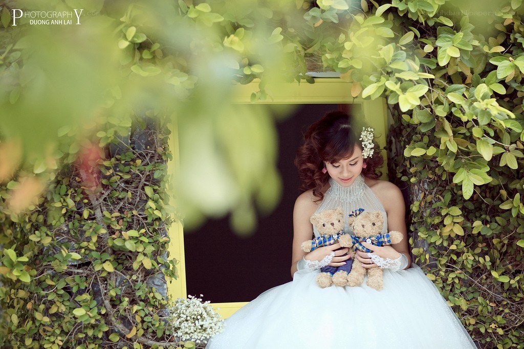 Bride with teddy bears in garden