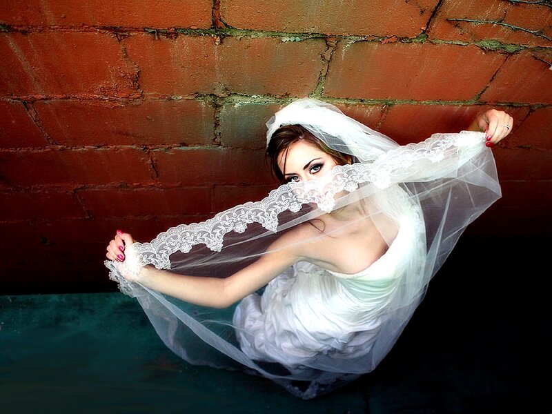 Bride with veil in alley