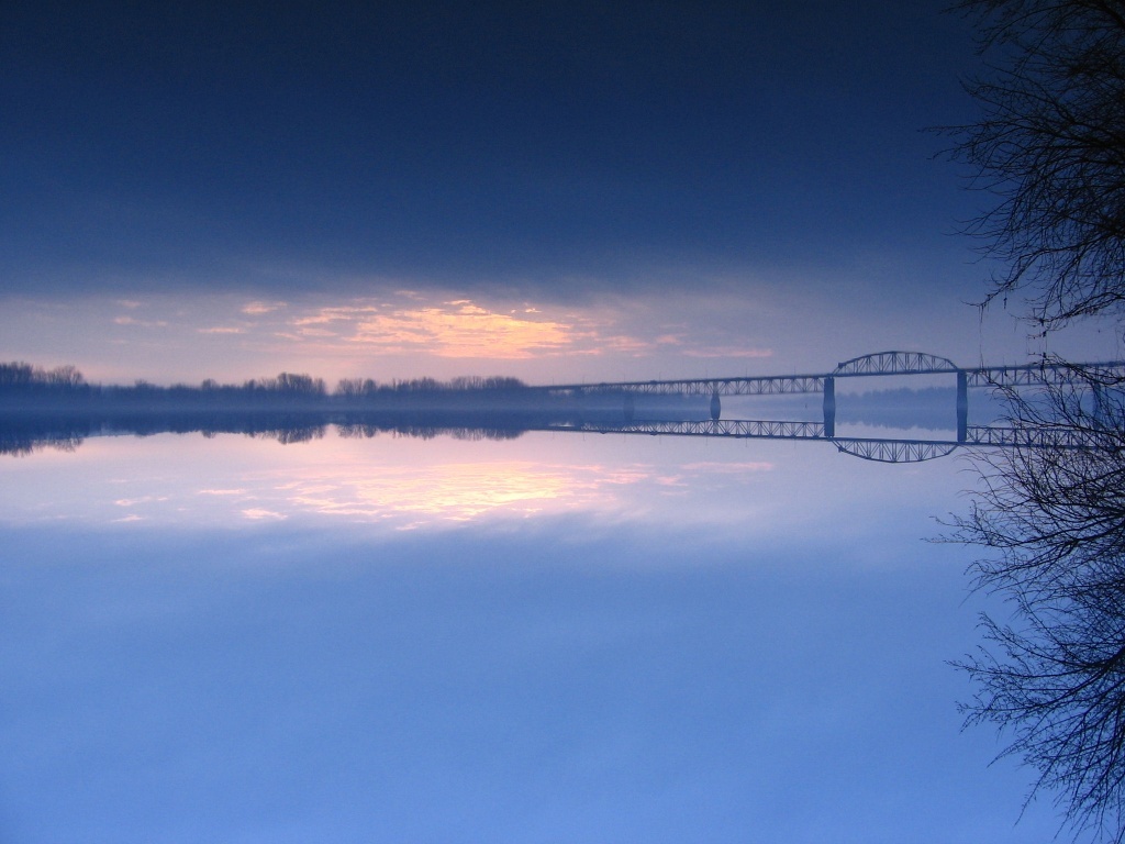Bridge at dawn over calm water