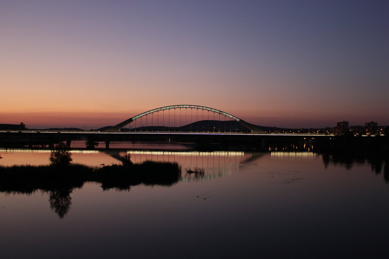 Bridge at dusk over calm river