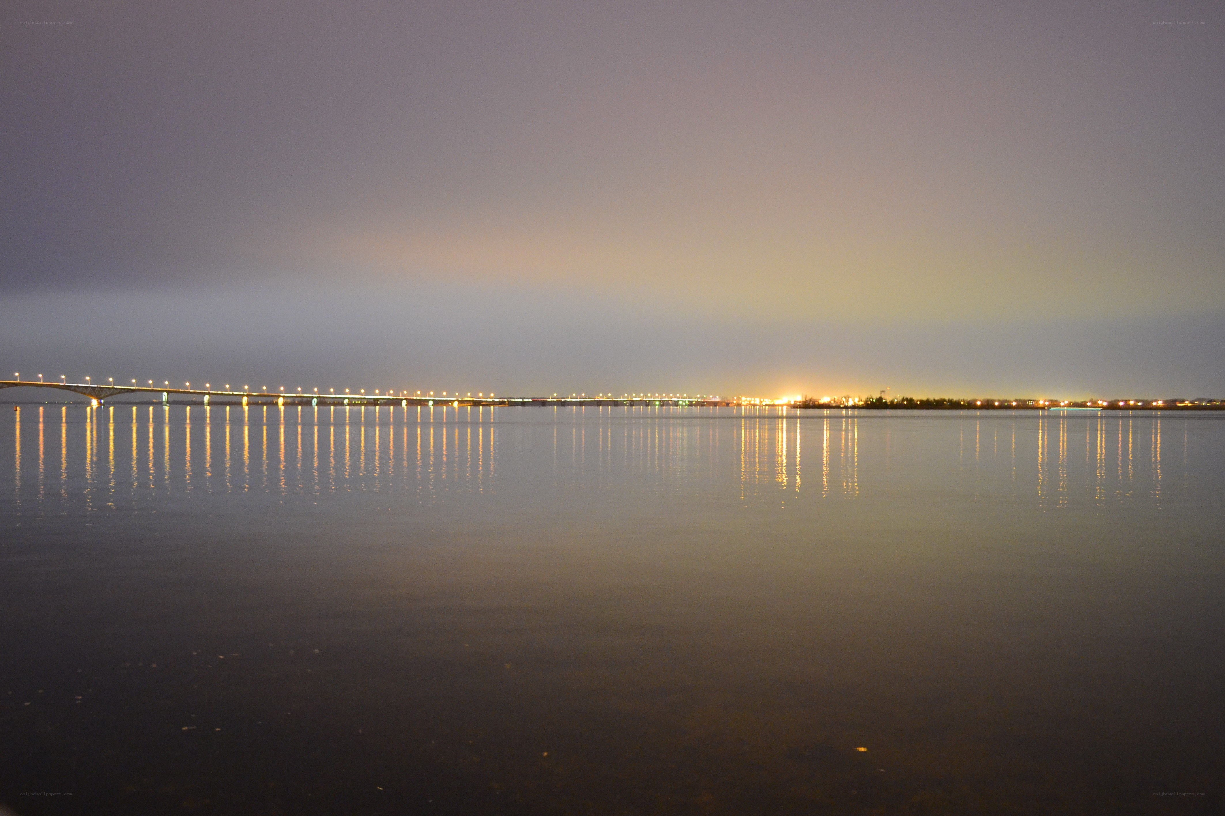 Bridge at dusk over calm water