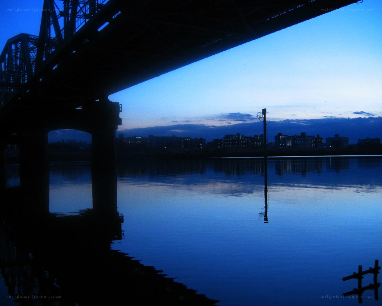 Bridge at dusk over calm water