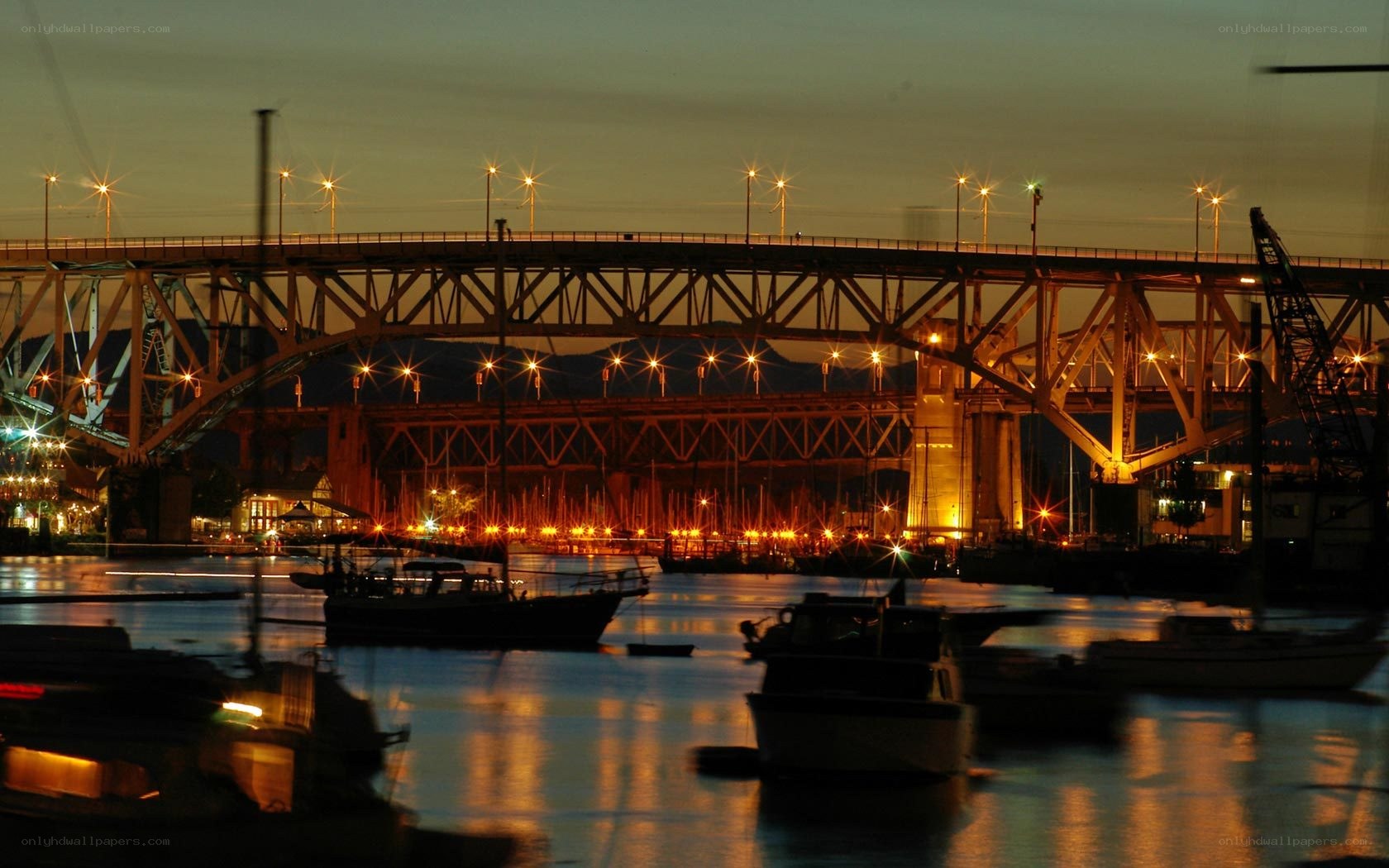 Bridge at dusk with boats