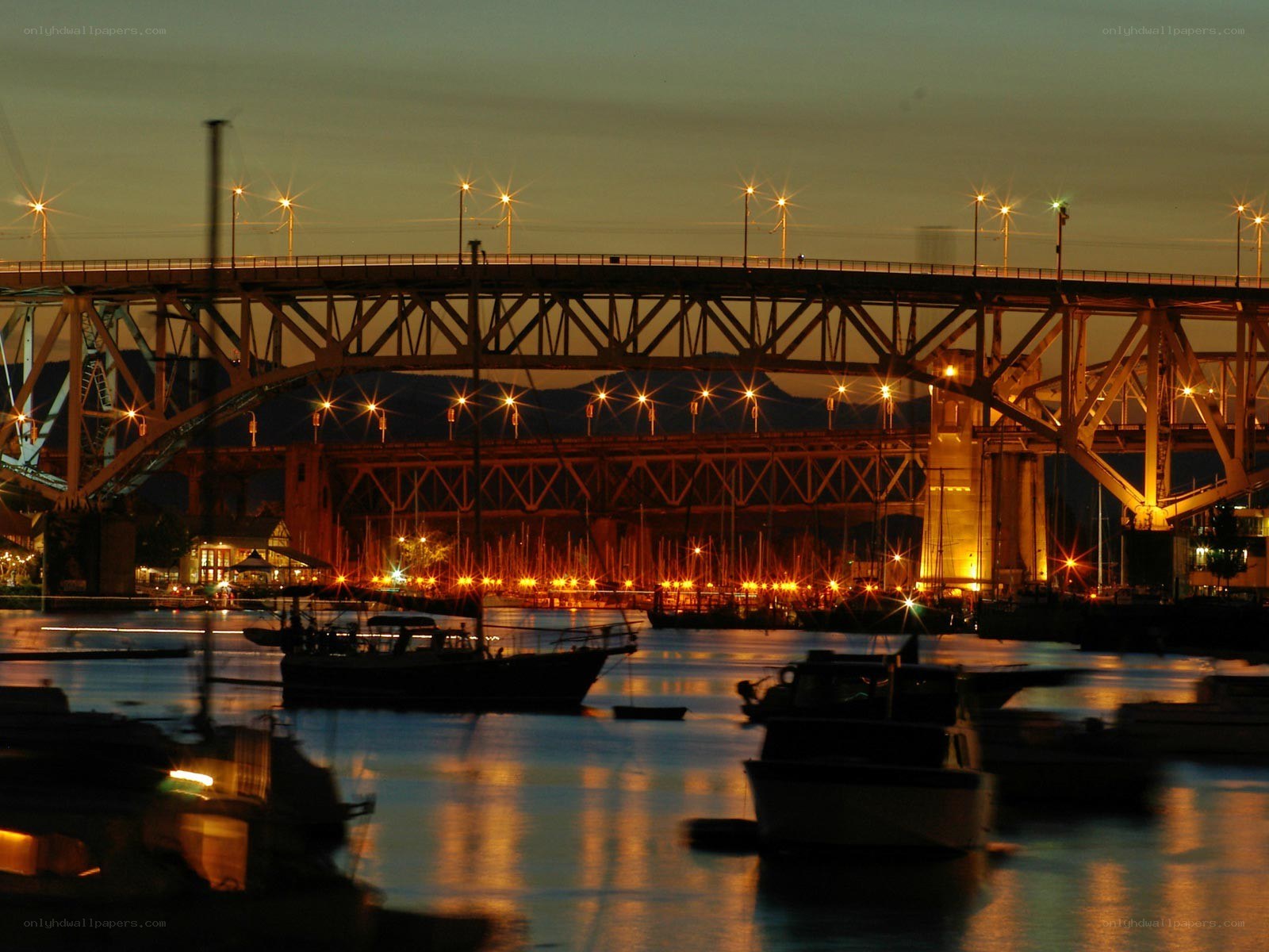 Bridge at dusk with boats