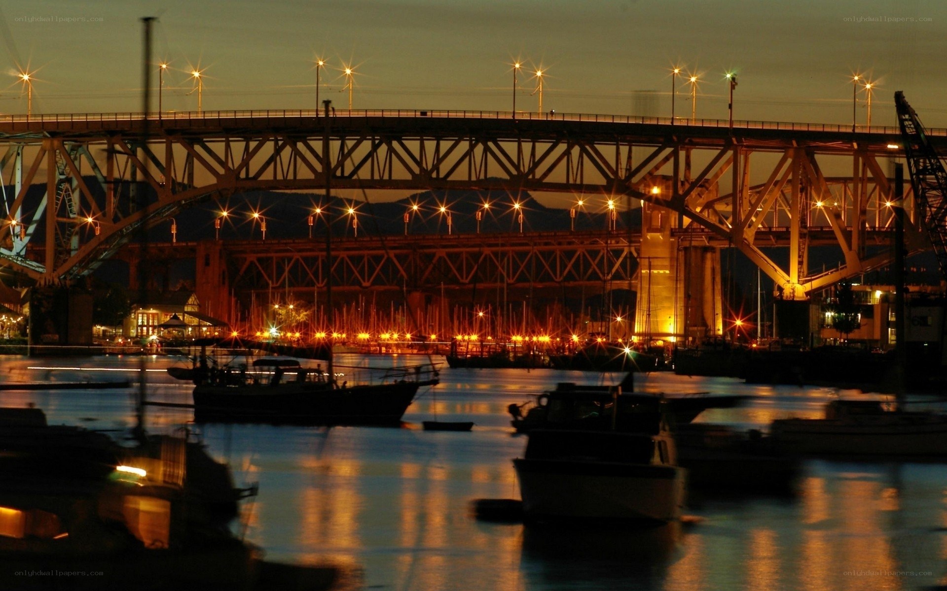 Bridge at dusk with boats