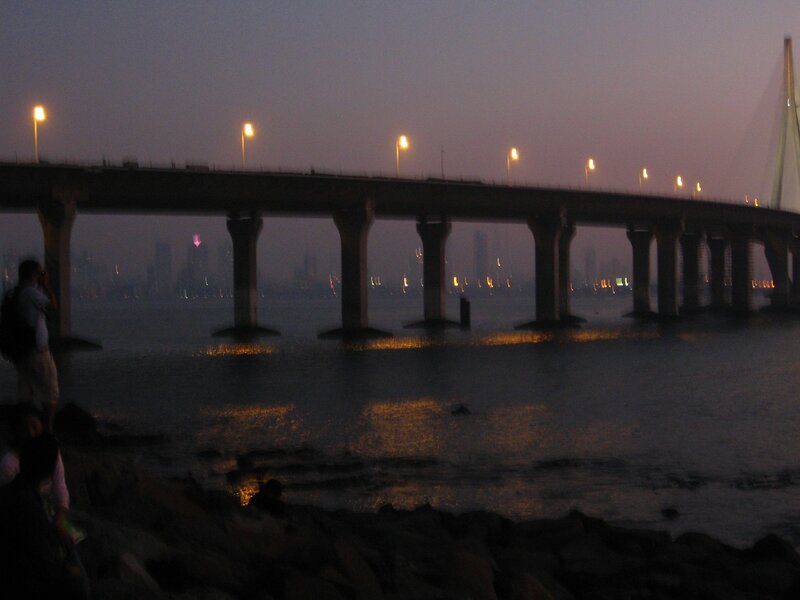 Bridge at dusk with city lights