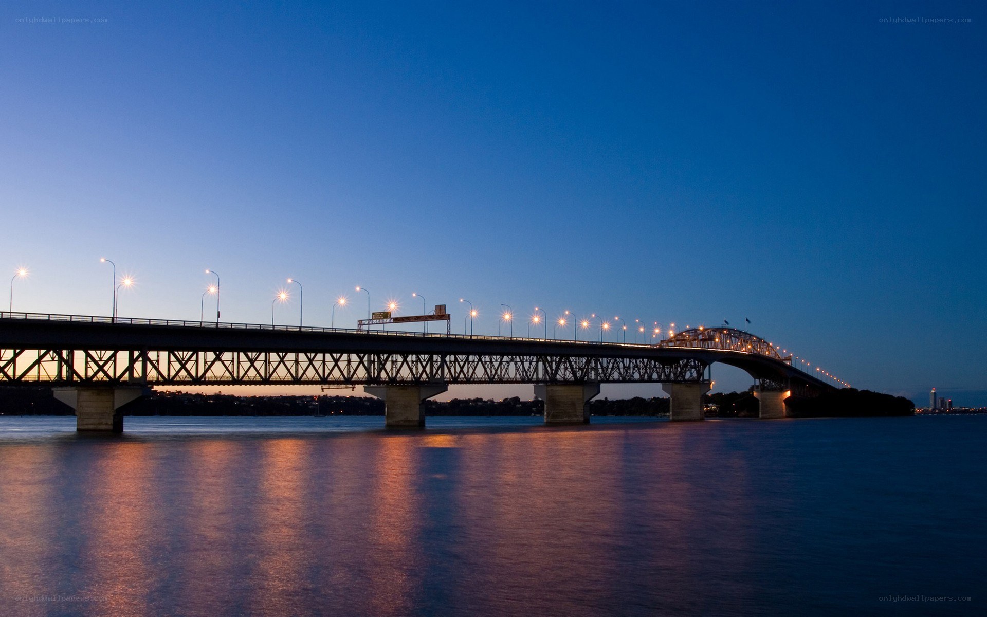 Bridge at dusk with city lights