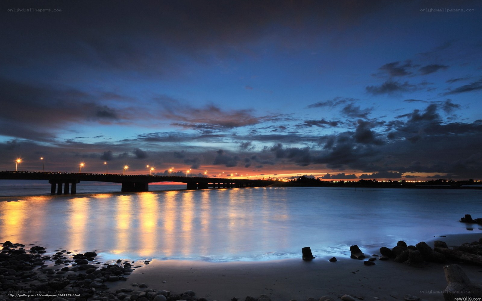 Bridge at dusk with city lights