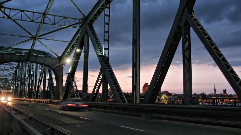 Bridge at dusk with city skyline