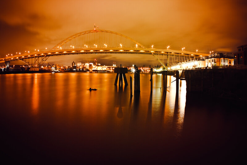 Bridge at night with city lights