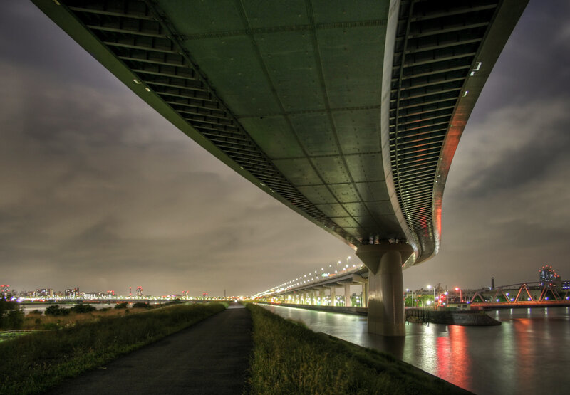 Bridge at night with city lights