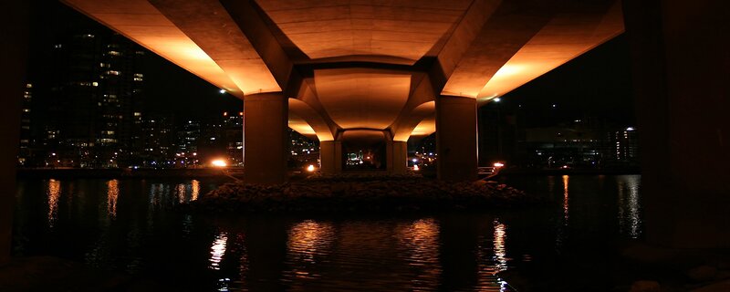 Bridge at night with city lights
