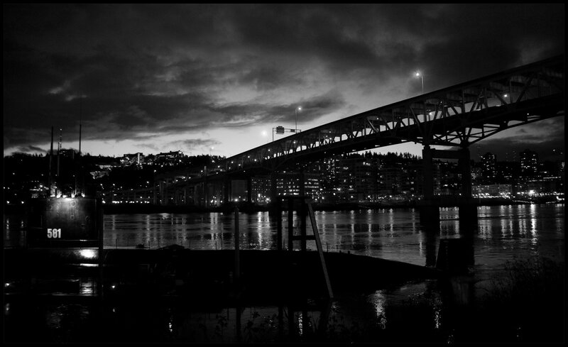 Bridge at night with city lights
