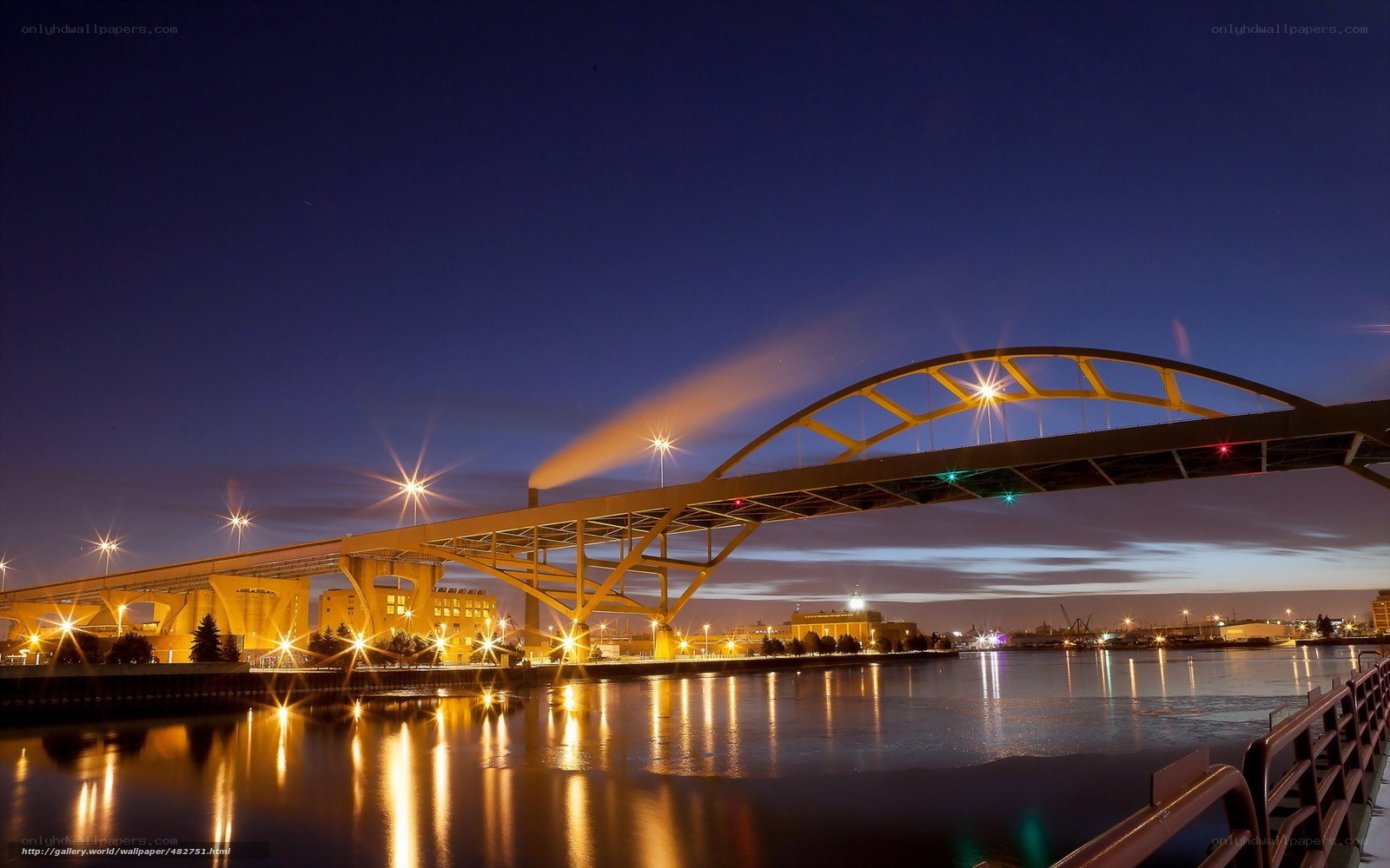 Bridge at night with city lights