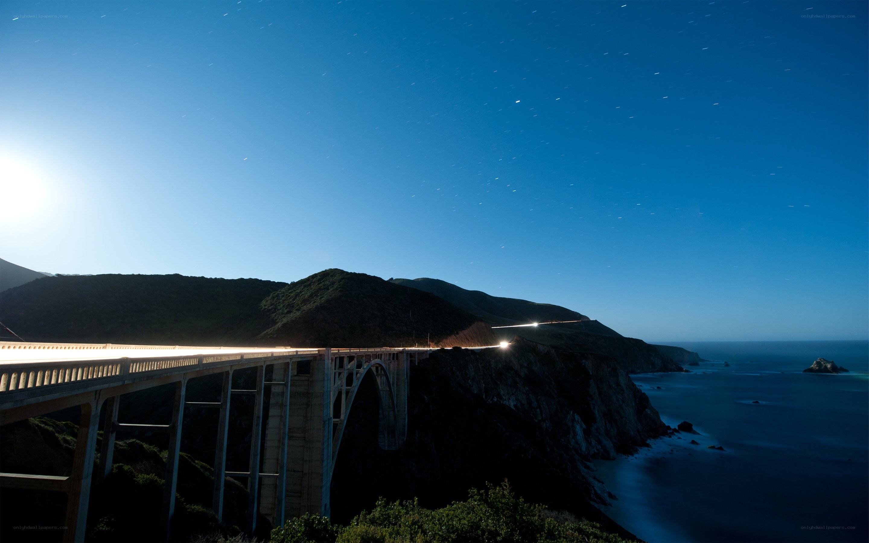 Bridge at night with star trails