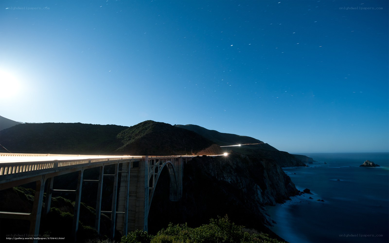 Bridge at night with star trails