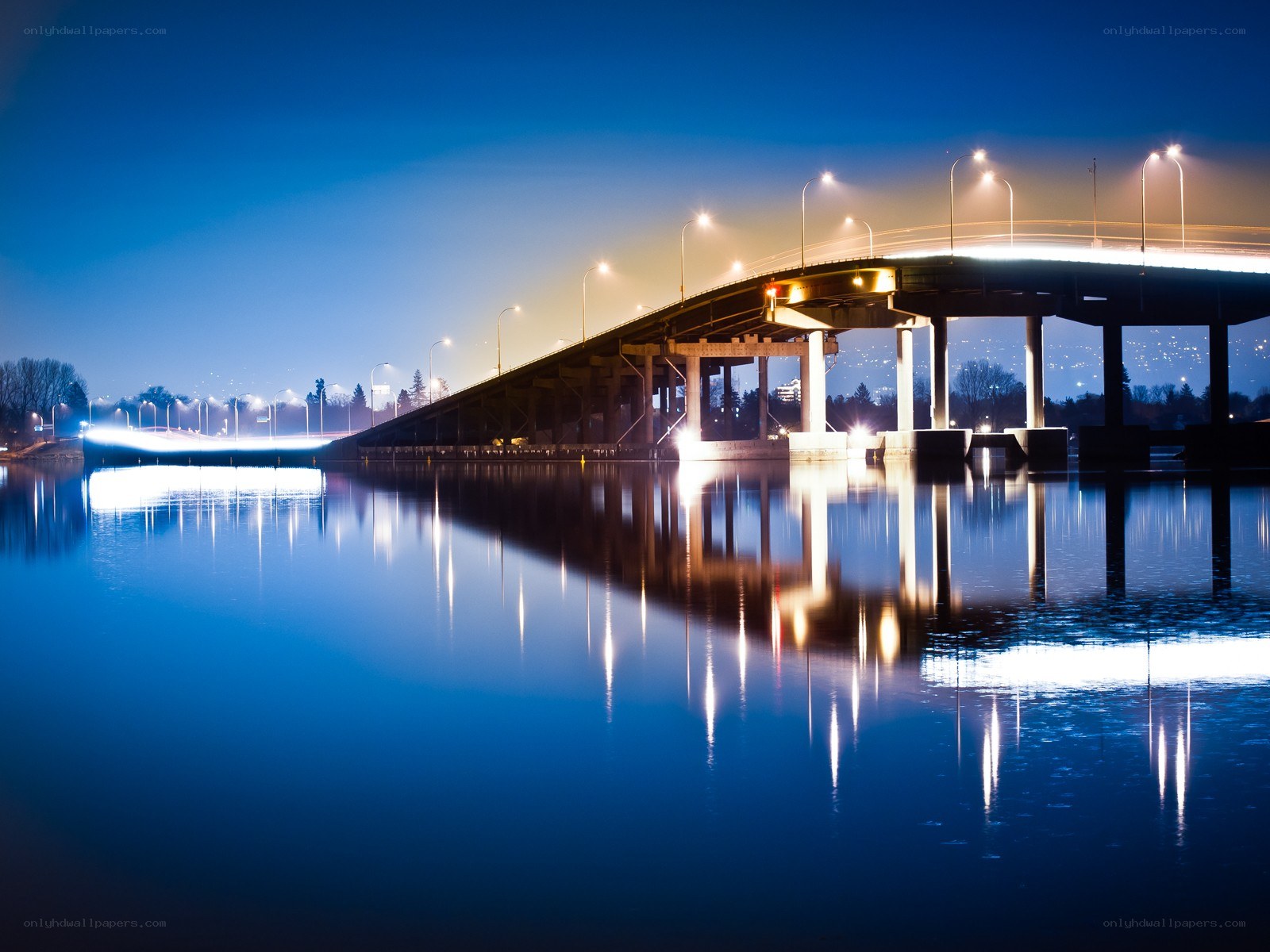 Bridge at night with water reflection