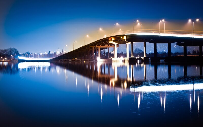Bridge at night with water reflection