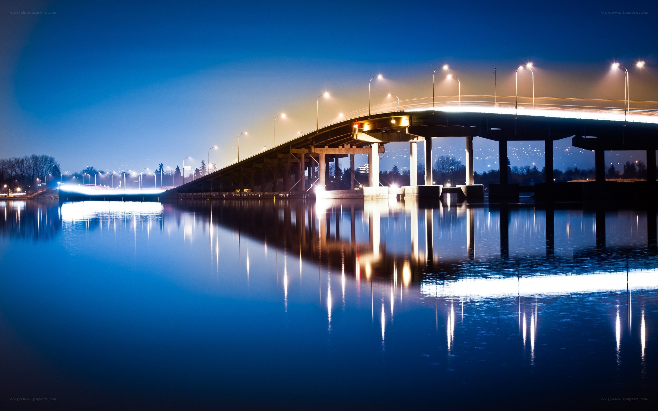 Bridge at night with water reflection