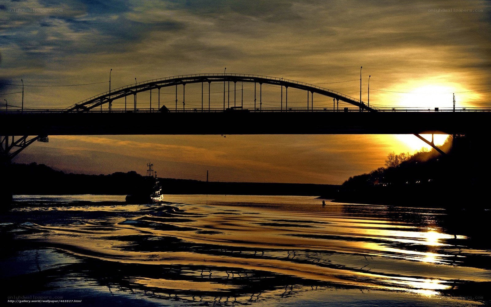 Bridge at sunset with boat
