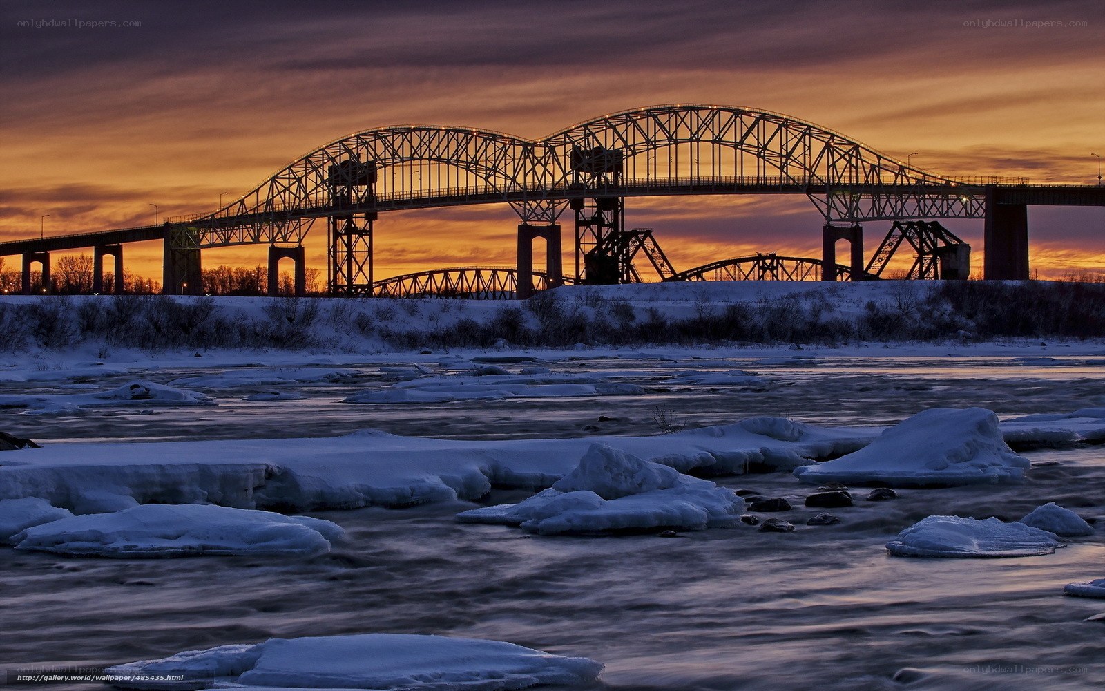 Bridge at sunset with ice floes