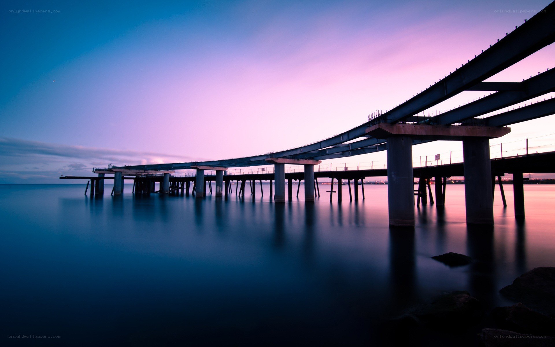 Bridge at twilight over calm water