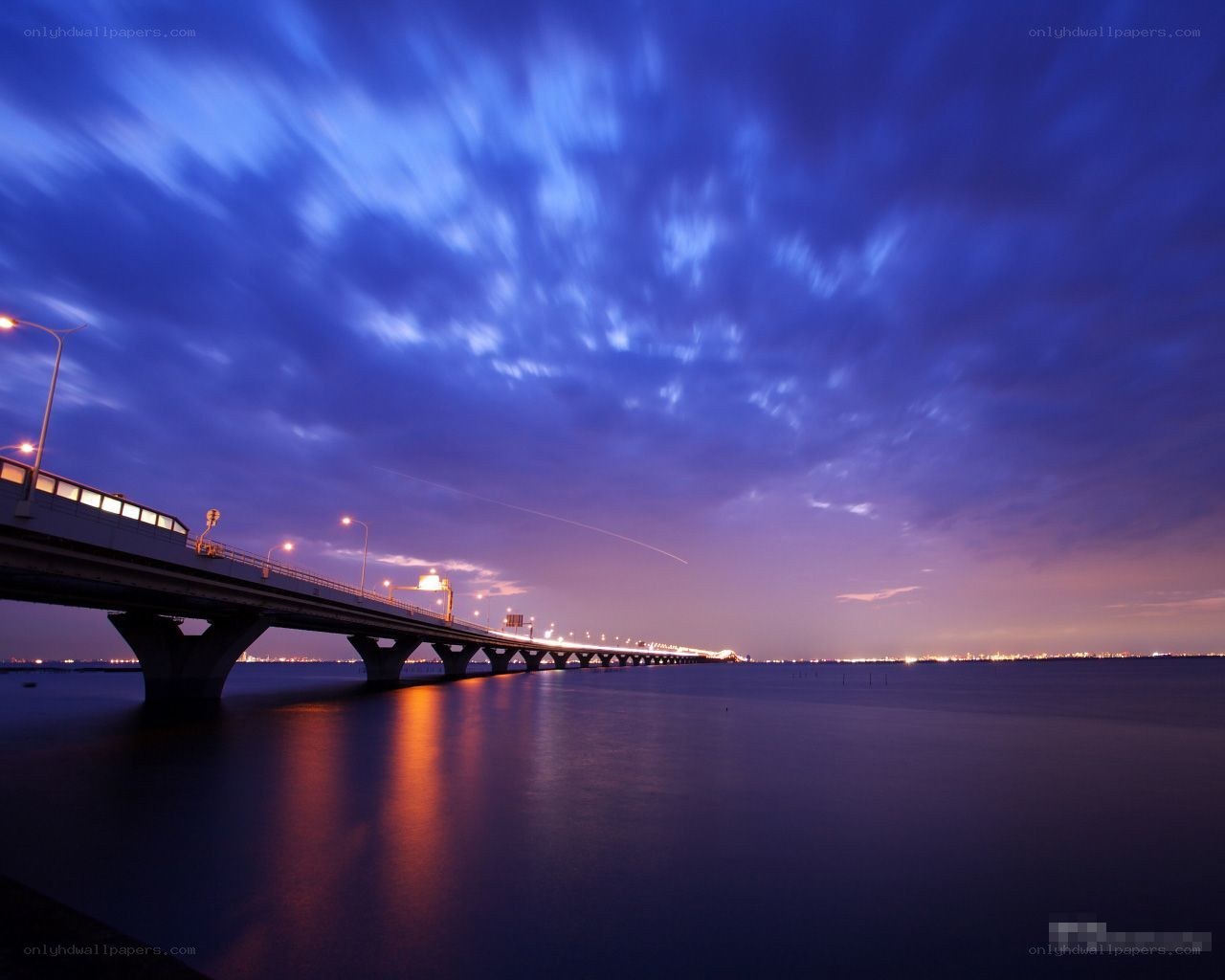 Bridge at twilight with city lights