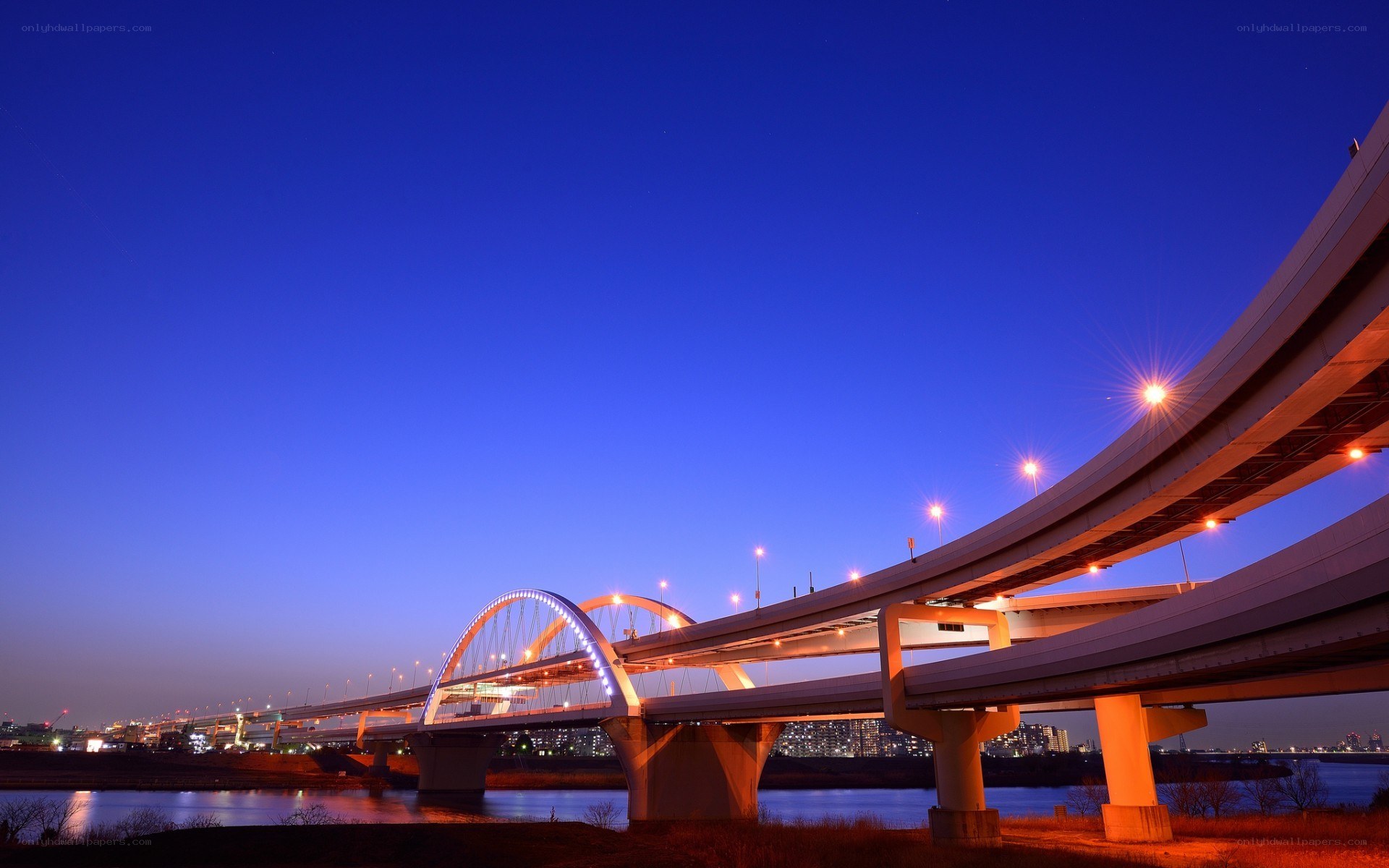 Bridge at twilight with city lights