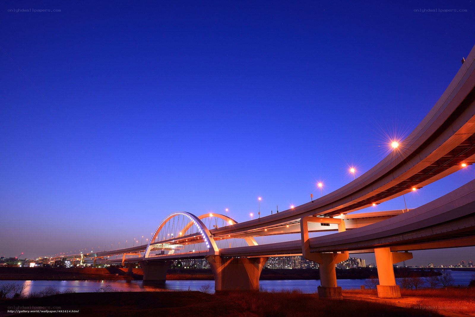 Bridge at twilight with city lights