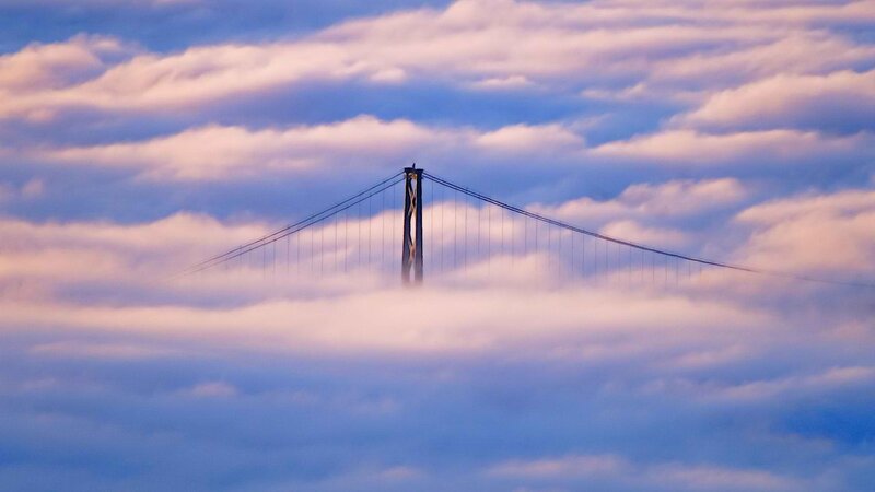 Bridge emerging from clouds