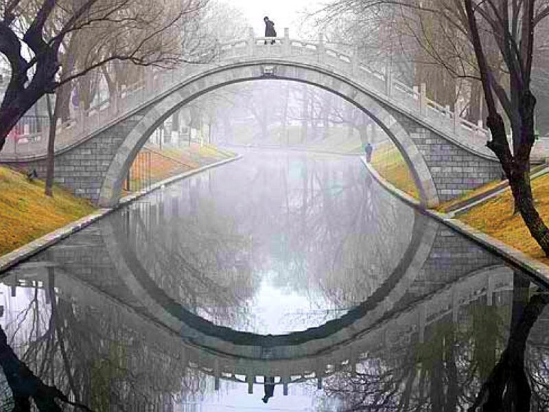 Bridge over a canal in fog