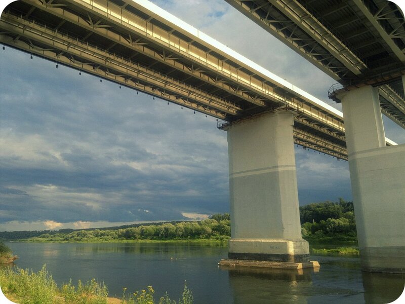 Bridge over a river under cloudy sky