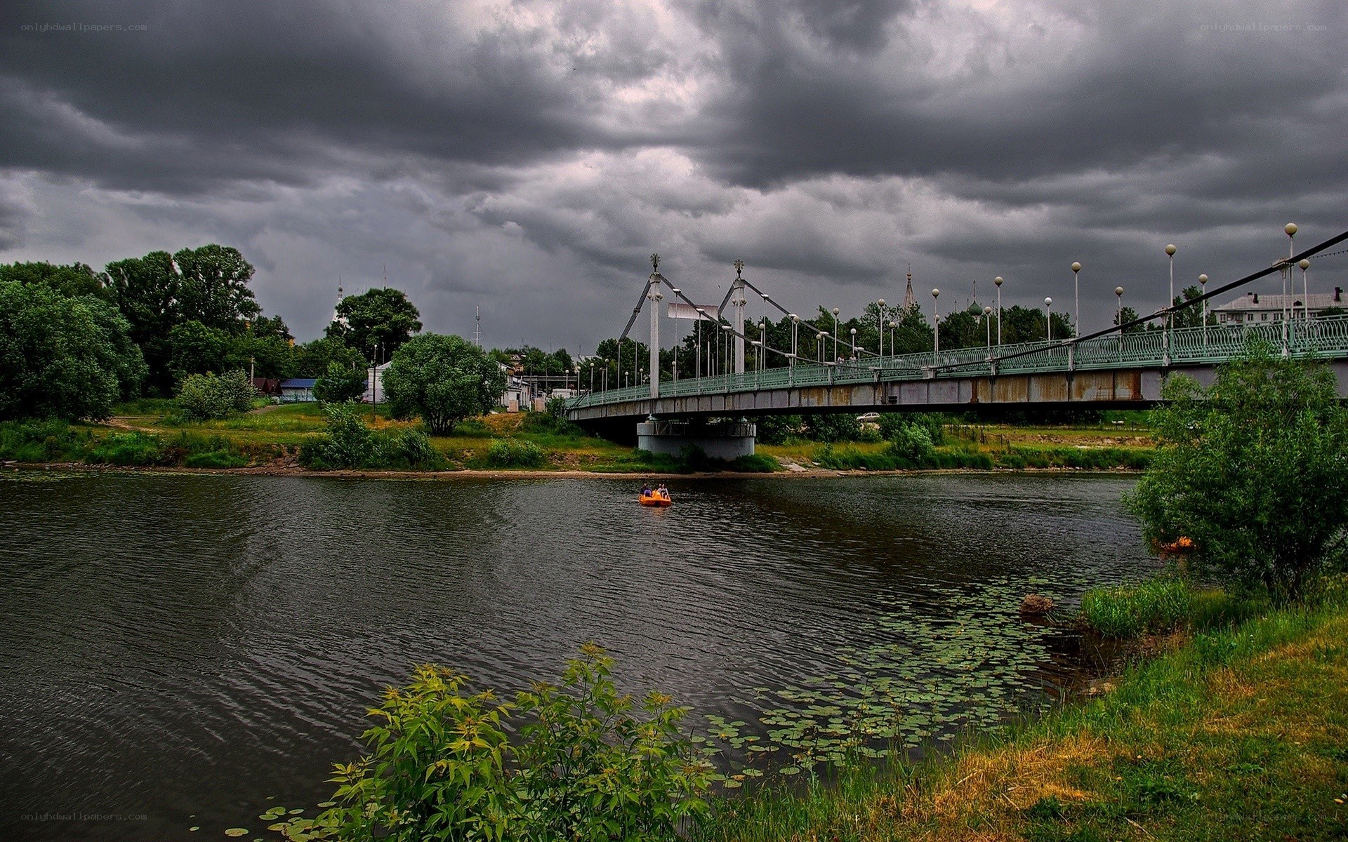 Bridge over a river under stormy sky