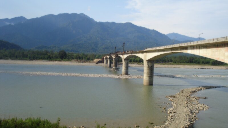 Bridge over a river with mountains