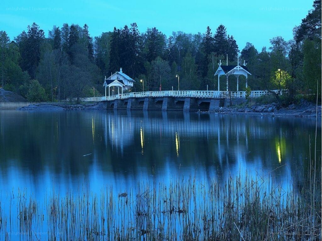 Bridge over calm lake at dusk