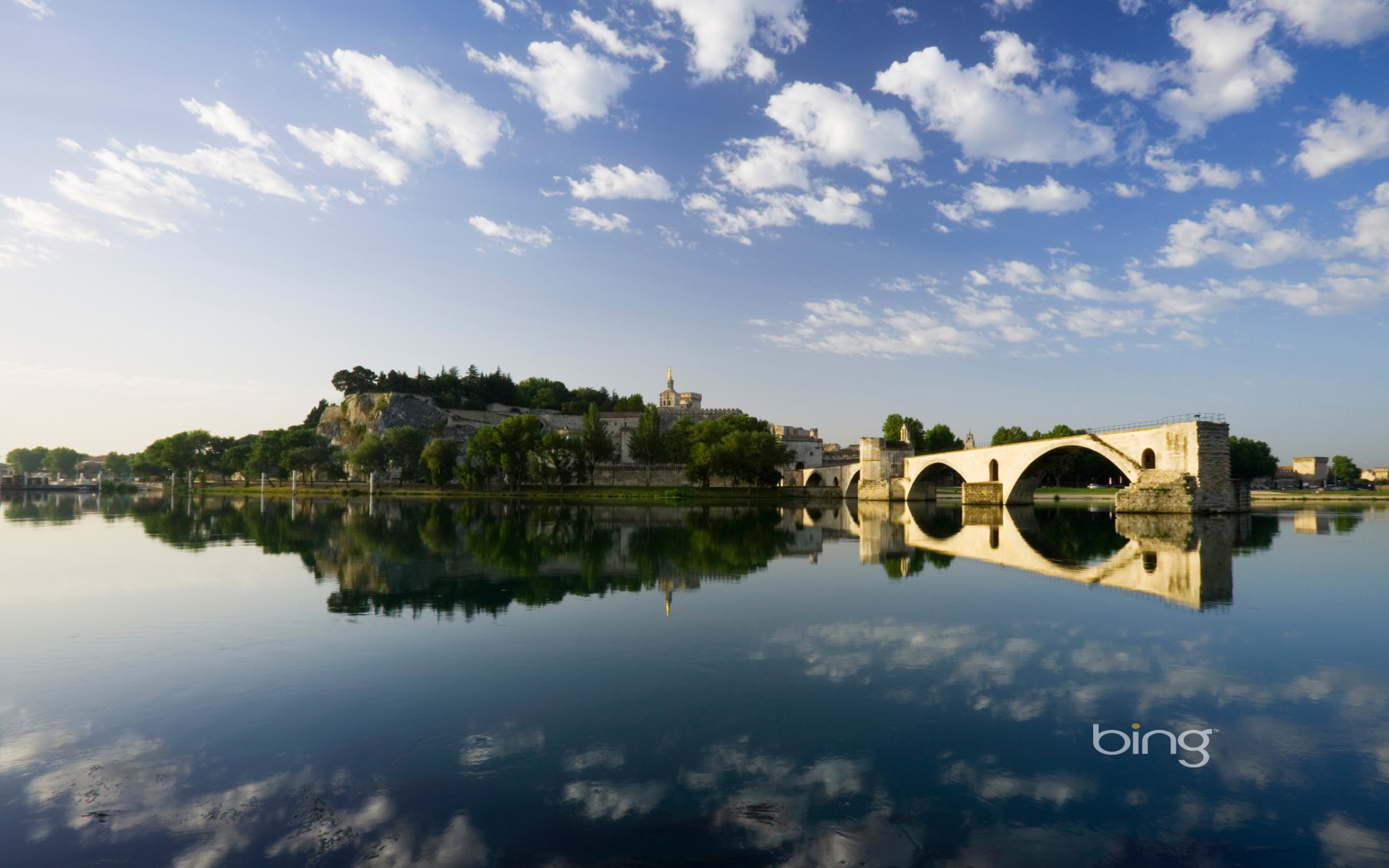 Bridge over calm river at dawn