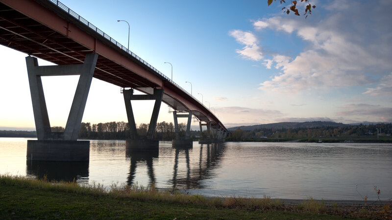 Bridge over calm river at dusk