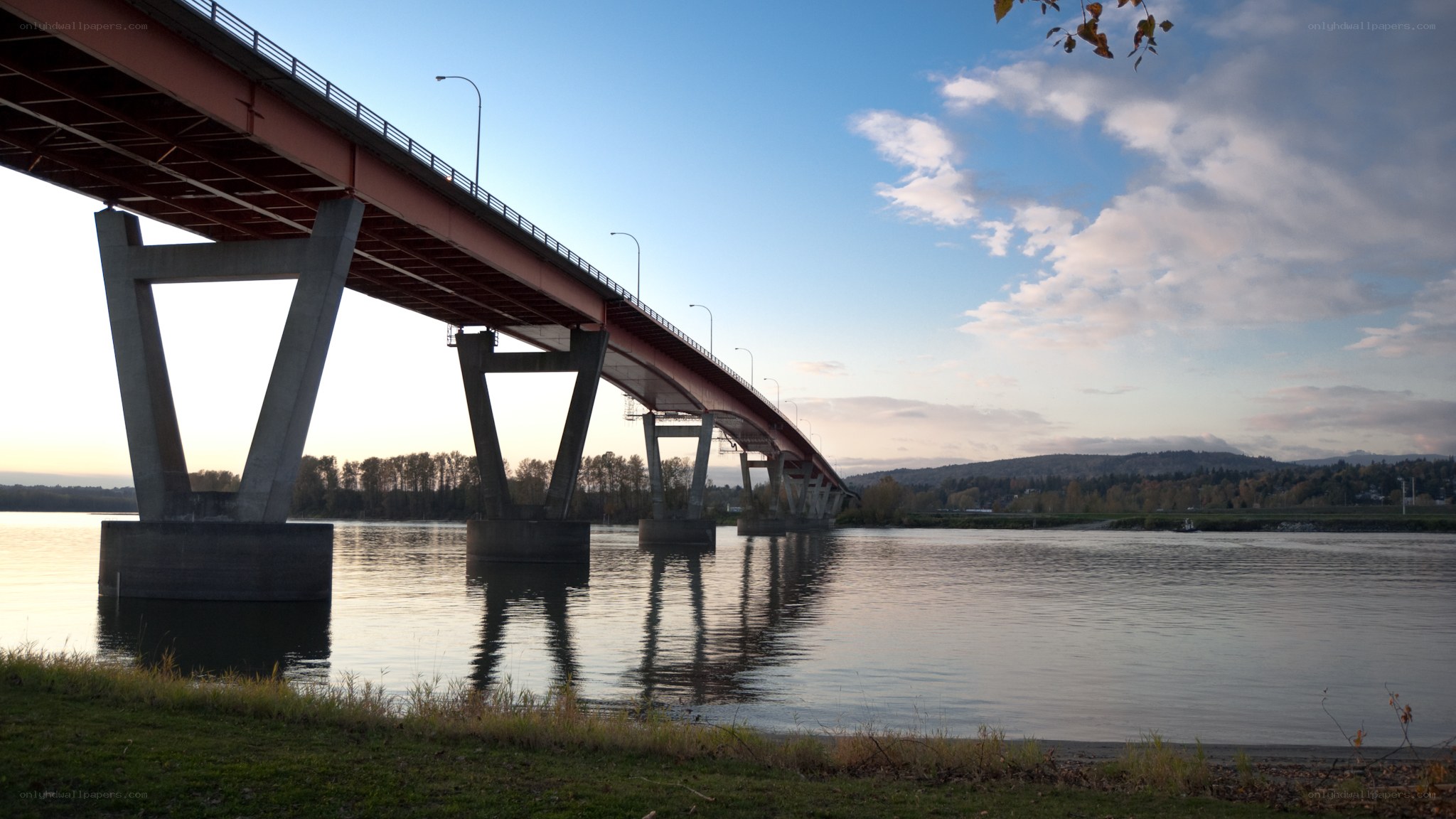 Bridge over calm river at dusk