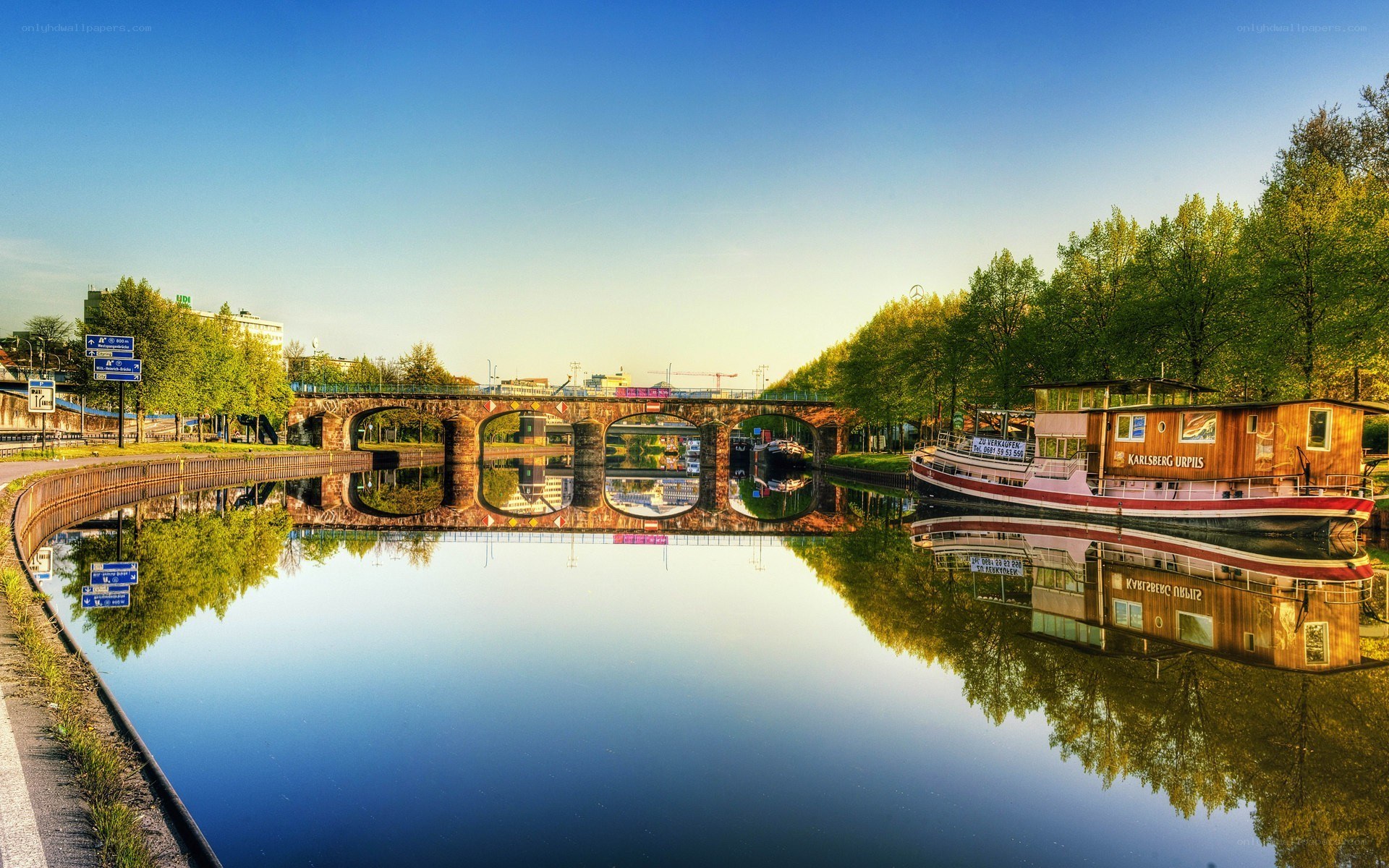 Bridge over calm river at sunset